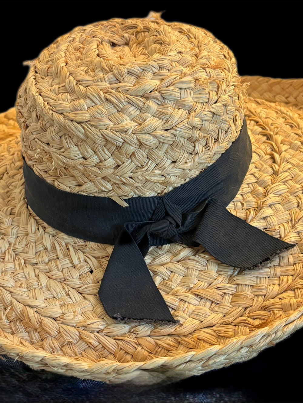 Helen Kaminski raffia sun hat featuring a classic woven design with a black gros